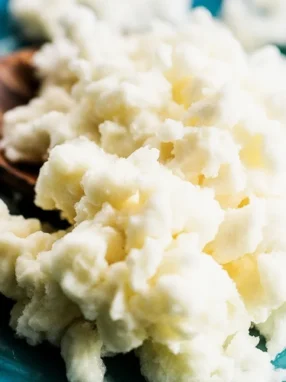 Kefir in a glass with a creamy texture and fizzy appearance, highlighting its tangy taste.