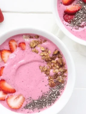 Creamy yogurt kefir smoothie bowl topped with mixed berries and granola.