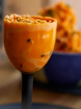 Fermented Kefir Carrot Slaw in a mason jar with fresh carrots, yogurt, and spices.