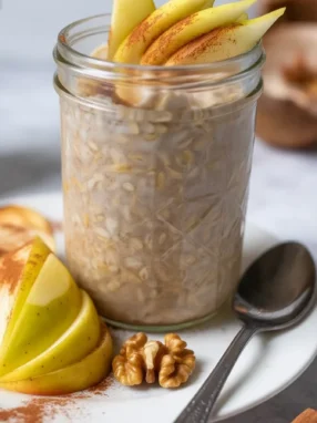 Bowl of Spiced Kefir Overnight Oats topped with fresh fruits and spices.