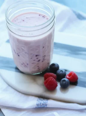 Yogurt-Kefir Protein Shake with bananas and berries in a blender.