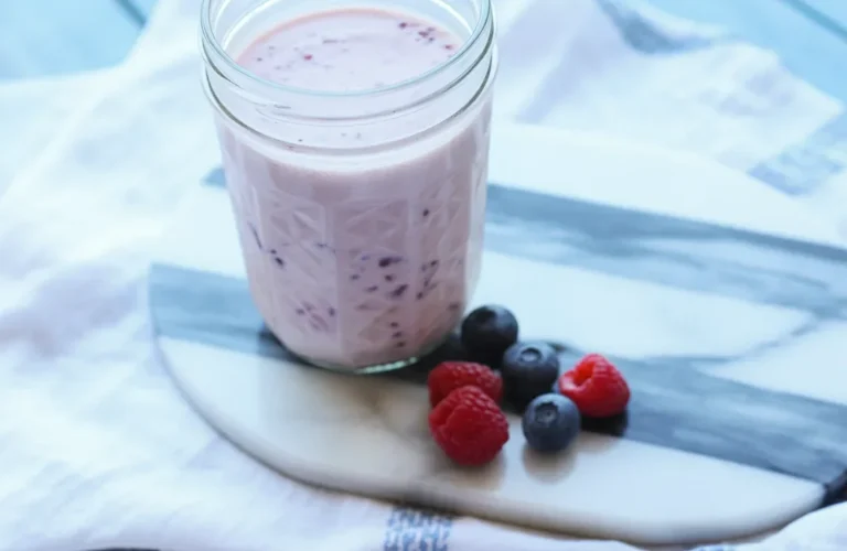 Yogurt-Kefir Protein Shake with bananas and berries in a blender.